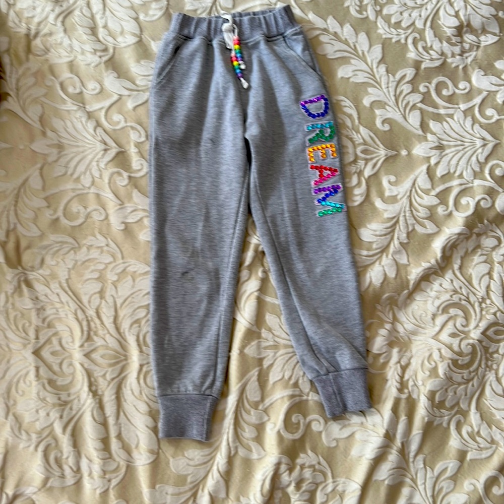 grey joggers with rainbow “DREAM” on the leg